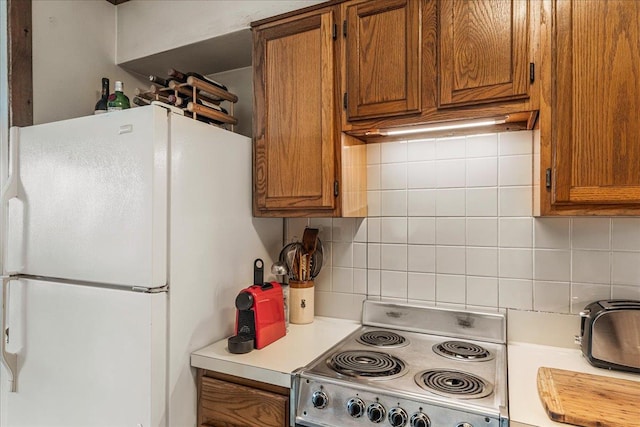 7-24 166th St Unit 8C, Beechhurst, NY 11357 - kitchen with white appliances, decorative backsplash, light countertops, and brown cabinetry