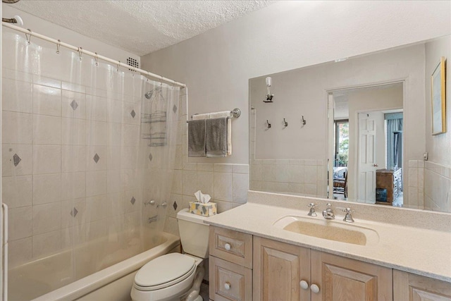 7-24 166th St Unit 8C, Beechhurst, NY 11357 - full bathroom with tile walls, a textured ceiling, shower / bath combination with curtain, vanity, and a wainscoted wall