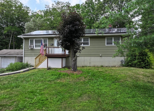 16-18 Claremont Ct, Middletown, NY 10940 - view of front facade featuring a front lawn, roof mounted solar panels, stairs, and a wooden deck