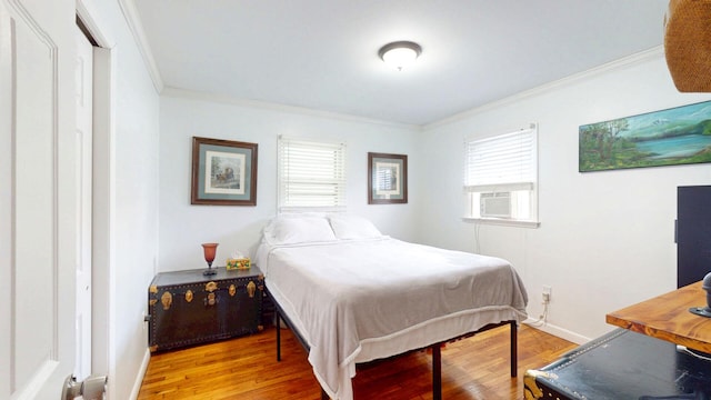 16-18 Claremont Ct, Middletown, NY 10940 - bedroom featuring ornamental molding, cooling unit, multiple windows, and wood finished floors