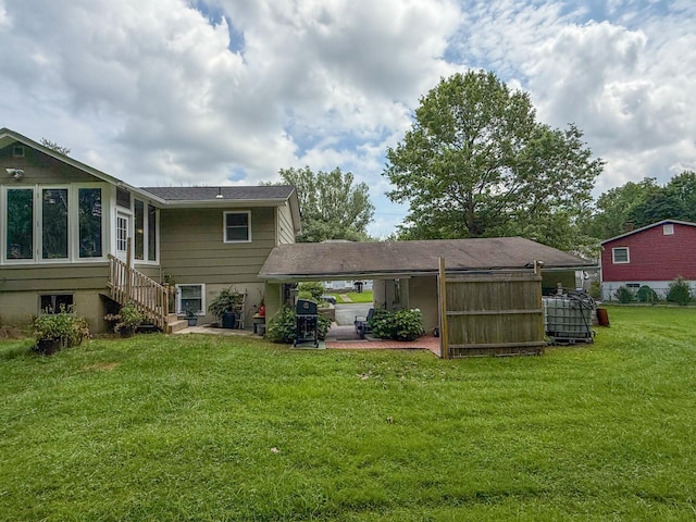 16-18 Claremont Ct, Middletown, NY 10940 - rear view of property featuring a lawn, a carport, and stairway