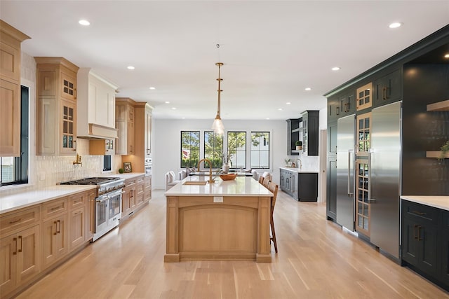 23 Sylvan Rd, Rye Brook, NY 10573 - kitchen with appliances with stainless steel finishes, light countertops, light wood finished floors, recessed lighting, and tasteful backsplash