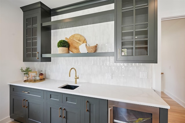 23 Sylvan Rd, Rye Brook, NY 10573 - indoor wet bar with tasteful backsplash, beverage cooler, and light wood finished floors