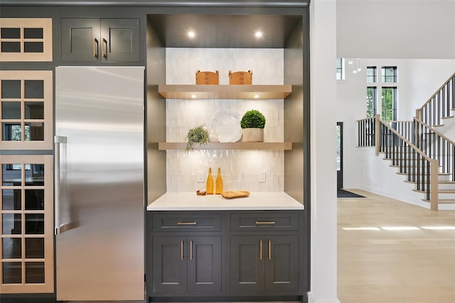 23 Sylvan Rd, Rye Brook, NY 10573 - kitchen with high end fridge, open shelves, light countertops, light wood-type flooring, and gray cabinetry