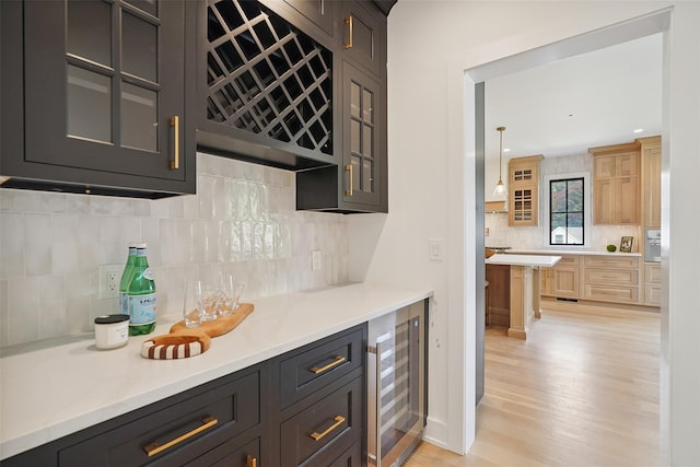 23 Sylvan Rd, Rye Brook, NY 10573 - indoor bar featuring beverage cooler, tasteful backsplash, light wood-type flooring, and recessed lighting