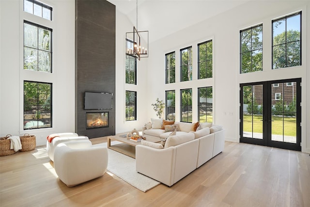 23 Sylvan Rd, Rye Brook, NY 10573 - living room with a high ceiling, a large fireplace, plenty of natural light, and wood finished floors