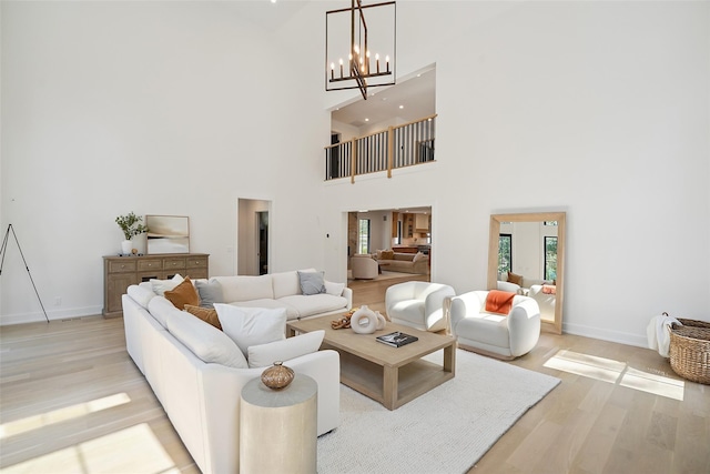 23 Sylvan Rd, Rye Brook, NY 10573 - living area featuring light wood-type flooring, a high ceiling, and a chandelier