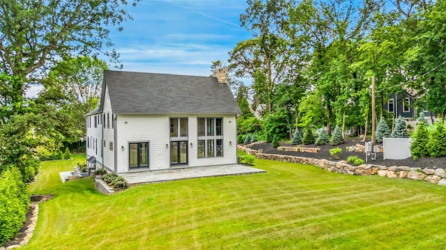 23 Sylvan Rd, Rye Brook, NY 10573 - back of house with a chimney, a patio, a yard, and a shingled roof