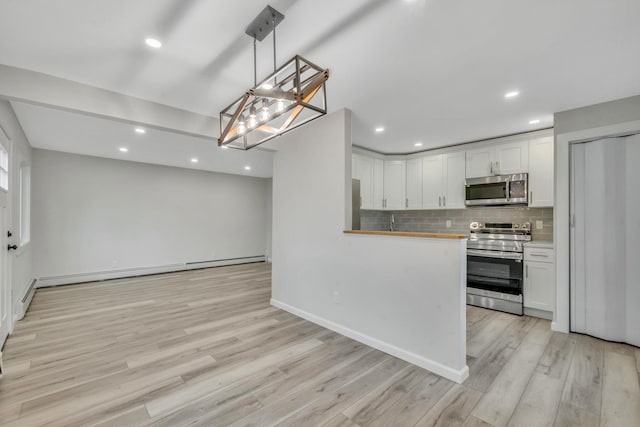 3 Auburn Ave, Bay Shore, NY 11706 - kitchen featuring stainless steel appliances, a baseboard radiator, white cabinets, tasteful backsplash, and light wood-style flooring