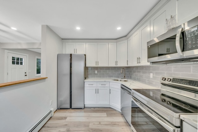 3 Auburn Ave, Bay Shore, NY 11706 - kitchen with stainless steel appliances, baseboard heating, white cabinets, and recessed lighting