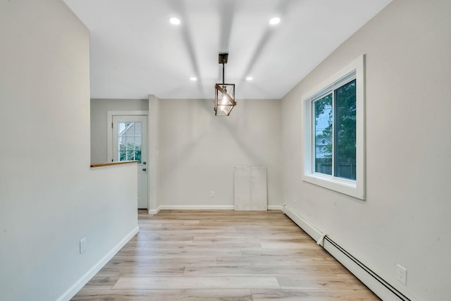 3 Auburn Ave, Bay Shore, NY 11706 - unfurnished dining area featuring baseboard heating, recessed lighting, and light wood-type flooring