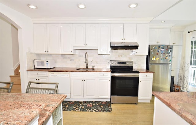 38 Loretta Dr, Syosset, NY 11791 - kitchen featuring stainless steel appliances, under cabinet range hood, light wood finished floors, white cabinetry, and light stone counters