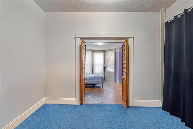 59-30 70th Ave, Ridgewood, NY 11385 - unfurnished bedroom featuring carpet and baseboards