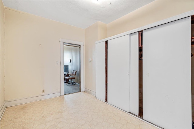 59-30 70th Ave, Ridgewood, NY 11385 - unfurnished bedroom with tile patterned floors, a closet, and a desk