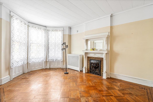59-30 70th Ave, Ridgewood, NY 11385 - unfurnished living room featuring radiator heating unit, a fireplace, and ornamental molding