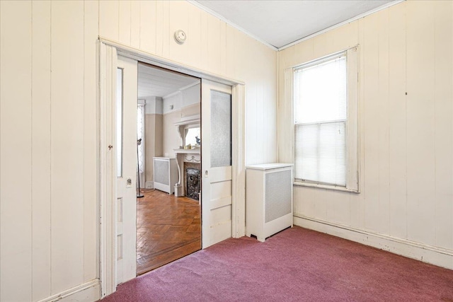 59-30 70th Ave, Ridgewood, NY 11385 - carpeted empty room featuring ornamental molding, radiator, and a fireplace