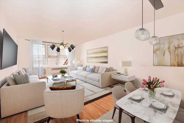 400 E 17th St Unit 600, Brooklyn, NY 11226 - living room featuring radiator, wood finished floors, and a chandelier