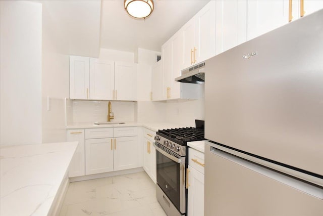 400 E 17th St Unit 600, Brooklyn, NY 11226 - kitchen featuring freestanding refrigerator, stainless steel gas range oven, under cabinet range hood, light marble finish floors, and white cabinetry
