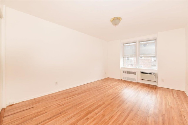 400 E 17th St Unit 600, Brooklyn, NY 11226 - empty room featuring radiator, light wood finished floors, and a wall unit AC