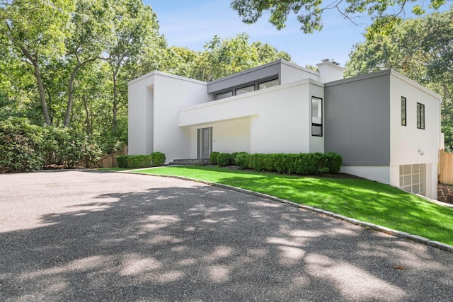 715 Hands Creek Rd, East Hampton, NY 11937 - view of front of house with stucco siding and a front lawn
