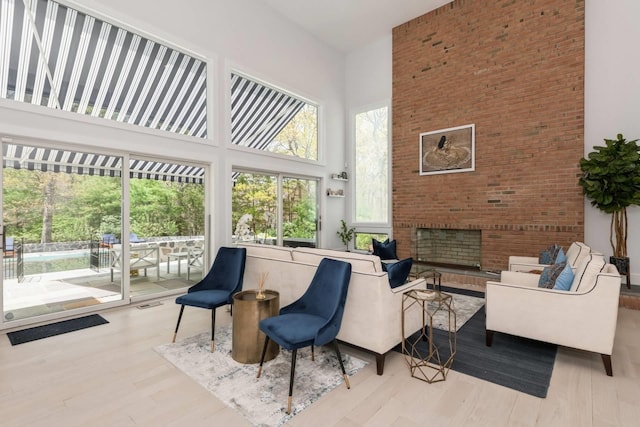 715 Hands Creek Rd, East Hampton, NY 11937 - living room with a high ceiling, wood finished floors, and a fireplace