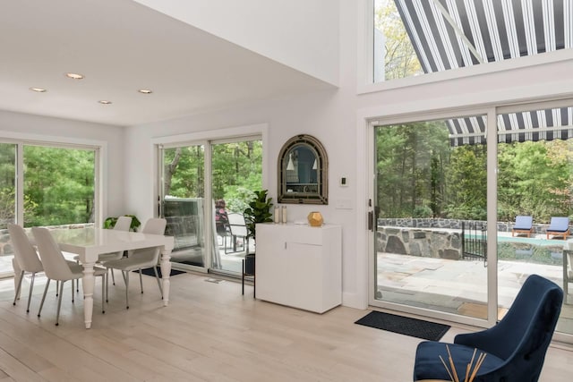715 Hands Creek Rd, East Hampton, NY 11937 - dining room featuring light wood-style floors, recessed lighting, and a towering ceiling