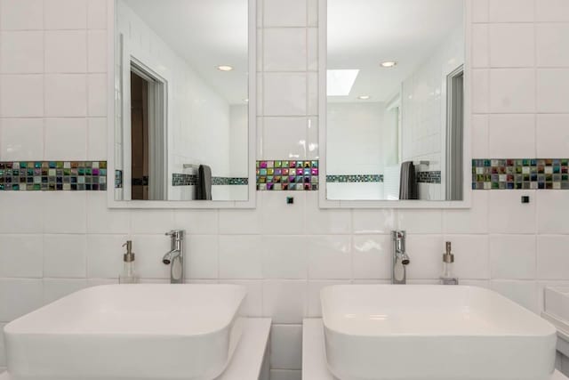 715 Hands Creek Rd, East Hampton, NY 11937 - bathroom with a skylight and tile walls