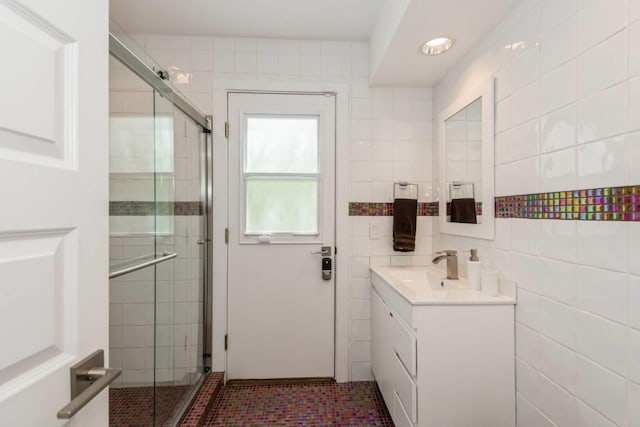 715 Hands Creek Rd, East Hampton, NY 11937 - bathroom featuring vanity, a stall shower, tile walls, and tile patterned floors