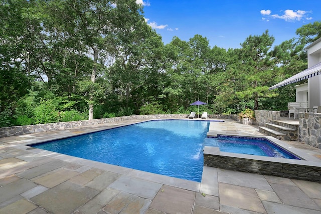 715 Hands Creek Rd, East Hampton, NY 11937 - view of swimming pool featuring a patio, a pool with connected hot tub, and view of scattered trees