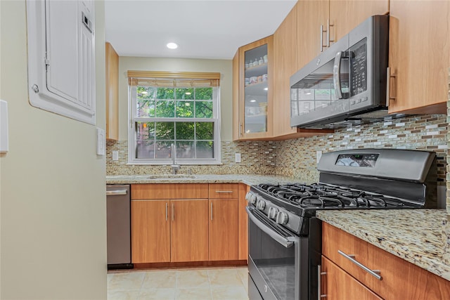 55 Oceana Dr E Unit 1B, Brooklyn, NY 11235 - kitchen featuring stainless steel appliances, light stone countertops, decorative backsplash, and recessed lighting