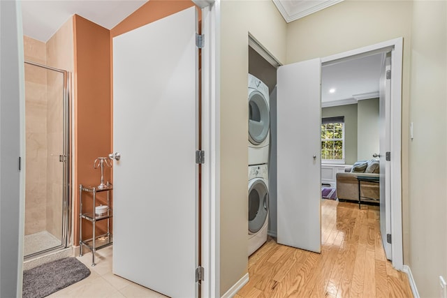 55 Oceana Dr E Unit 1B, Brooklyn, NY 11235 - washroom featuring estacked washer and dryer, ornamental molding, and light wood-style floors