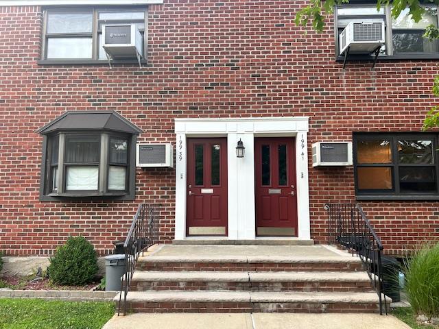 199-39 19th Ave Upper, Upper, Whitestone, NY 11357 - doorway to property featuring brick siding