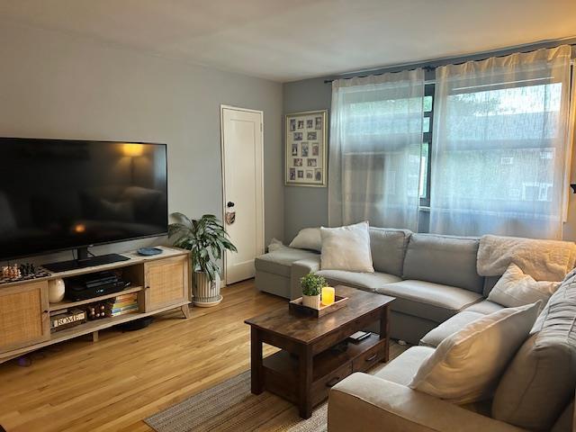 199-39 19th Ave Upper, Upper, Whitestone, NY 11357 - living area with plenty of natural light and light wood-style flooring