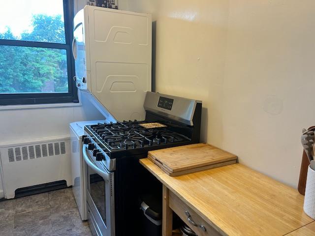 199-39 19th Ave Upper, Upper, Whitestone, NY 11357 - kitchen featuring gas range, radiator, and light countertops