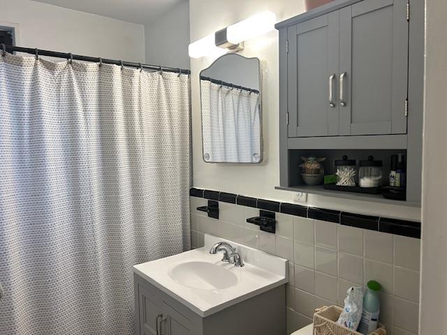 199-39 19th Ave Upper, Upper, Whitestone, NY 11357 - full bathroom featuring vanity, tile walls, and a shower with curtain