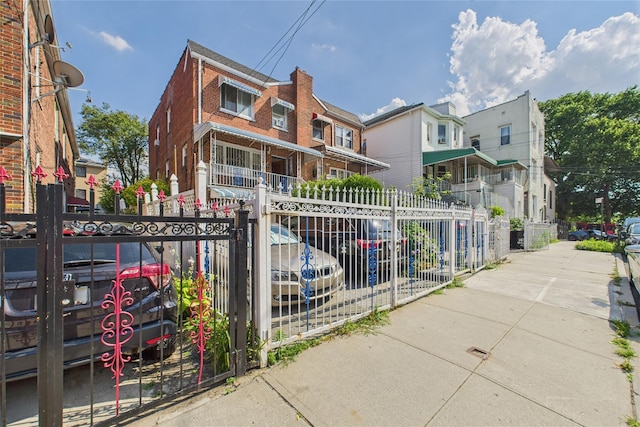 1472 Needham Ave, Bronx, NY 10469 - view of front facade featuring brick siding, a gate, and a residential view