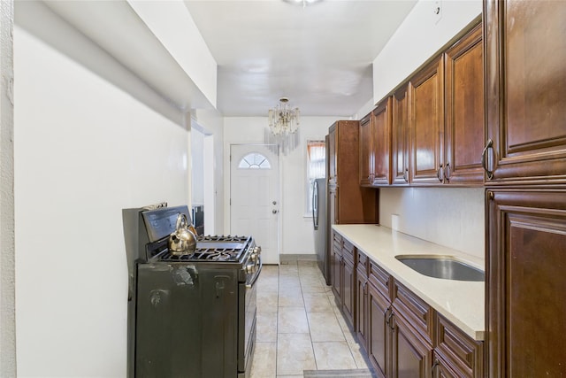 1472 Needham Ave, Bronx, NY 10469 - kitchen with stainless steel range with gas cooktop, light countertops, and a chandelier