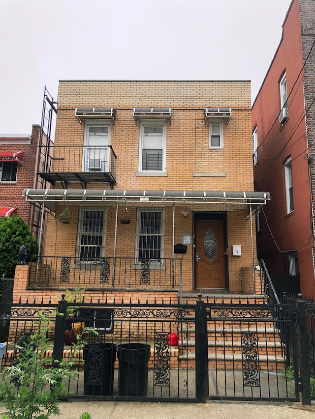 1038 E 224th St, Bronx, NY 10466 - view of front of home featuring brick siding, a fenced front yard, and a porch