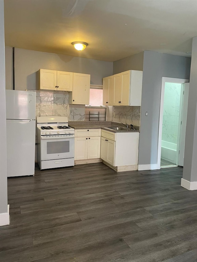 1038 E 224th St, Bronx, NY 10466 - kitchen with white appliances, decorative backsplash, dark wood-style flooring, and white cabinetry