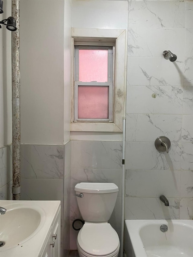 1038 E 224th St, Bronx, NY 10466 - full bathroom featuring tile walls, vanity, a wainscoted wall, and washtub / shower combination