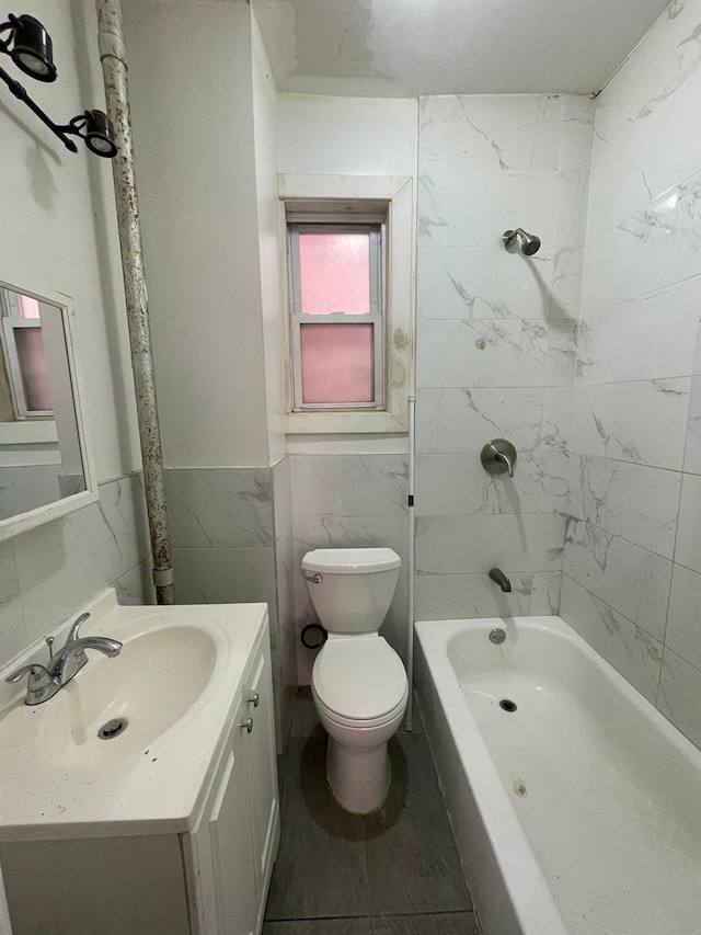 1038 E 224th St, Bronx, NY 10466 - bathroom with vanity, tile walls, bathing tub / shower combination, and wainscoting