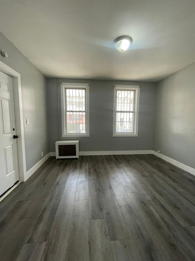 1038 E 224th St, Bronx, NY 10466 - spare room featuring healthy amount of natural light and dark wood finished floors