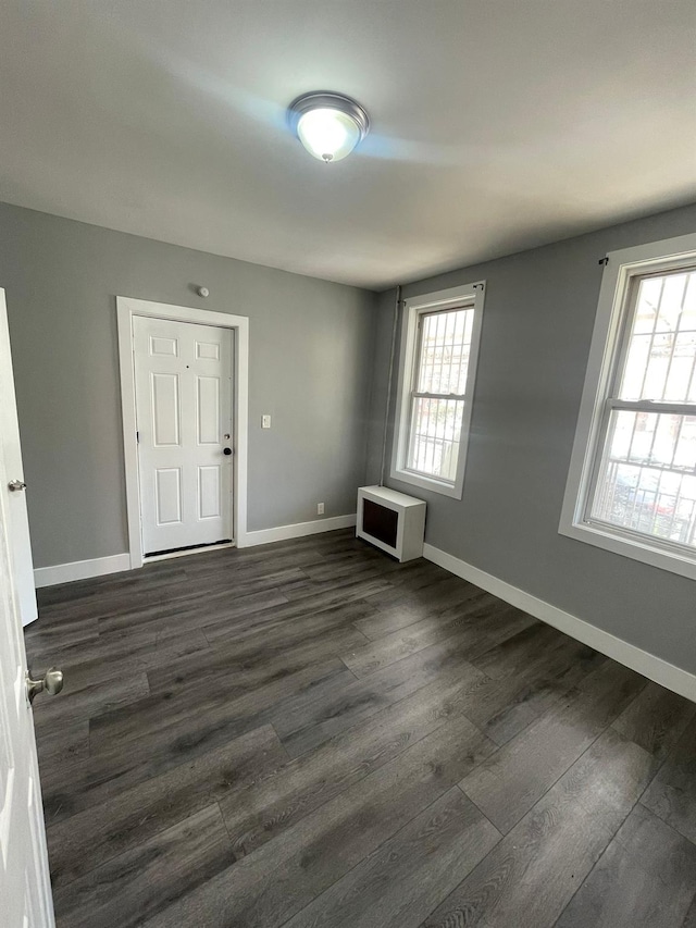 1038 E 224th St, Bronx, NY 10466 - unfurnished room with dark wood-style floors and heating unit