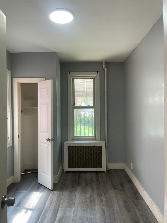 1038 E 224th St, Bronx, NY 10466 - unfurnished bedroom featuring wood finished floors, radiator heating unit, and a closet