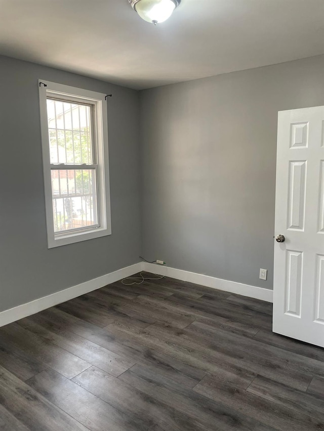 1038 E 224th St, Bronx, NY 10466 - spare room featuring dark wood-type flooring