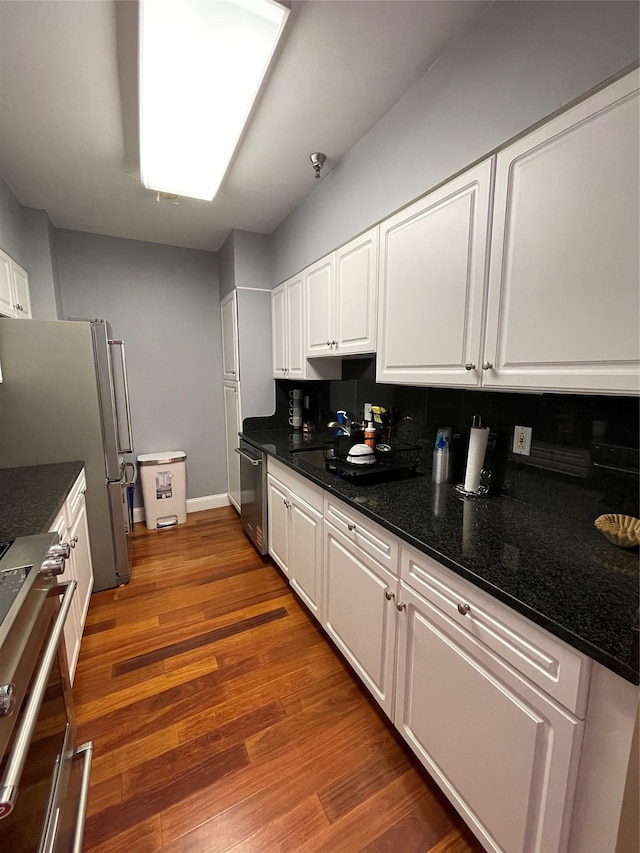 100 New Roc City Plz Unit 414, New Rochelle, NY 10801 - kitchen with stainless steel appliances, white cabinets, backsplash, and wood finished floors