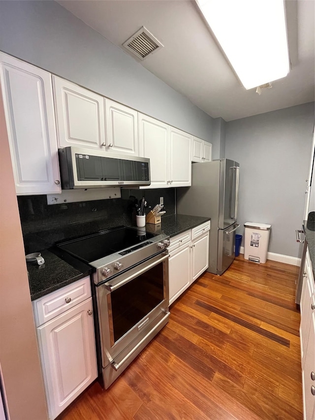 100 New Roc City Plz Unit 414, New Rochelle, NY 10801 - kitchen featuring appliances with stainless steel finishes, white cabinets, and wood finished floors