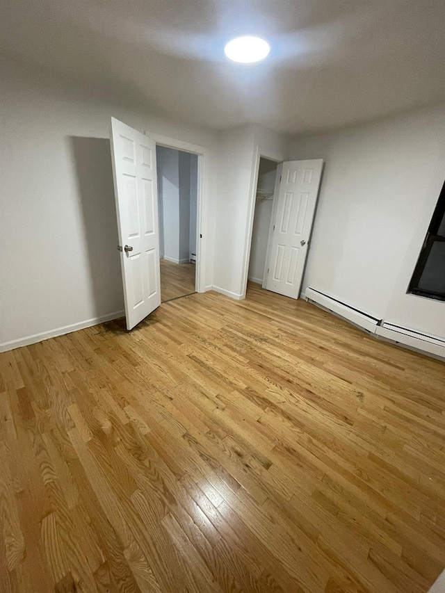 782 Cauldwell Ave, Bronx, NY 10456 - unfurnished bedroom featuring light wood-type flooring and baseboard heating