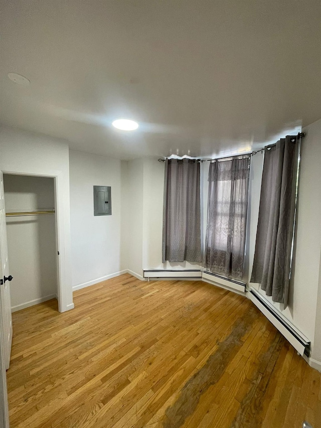 782 Cauldwell Ave, Bronx, NY 10456 - unfurnished bedroom with electric panel, light wood-style flooring, and a closet