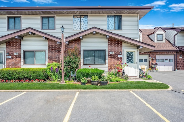 199 Cambridge Dr E, Copiague, NY 11726 - view of property with brick siding and uncovered parking